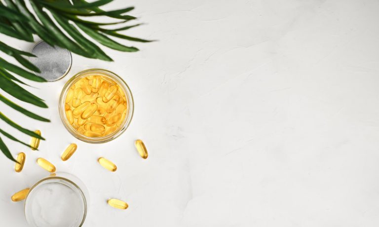 fish oil capsules with omega3 and vitamin d with glass jar