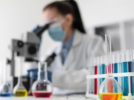 Patient Engagement – What History Teaches Us About Pharma’s Future Evolution blurry woman looking through microscope