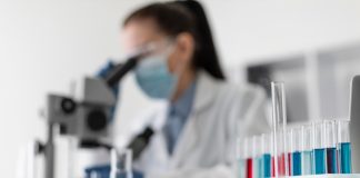 Patient Engagement – What History Teaches Us About Pharma’s Future Evolution blurry woman looking through microscope