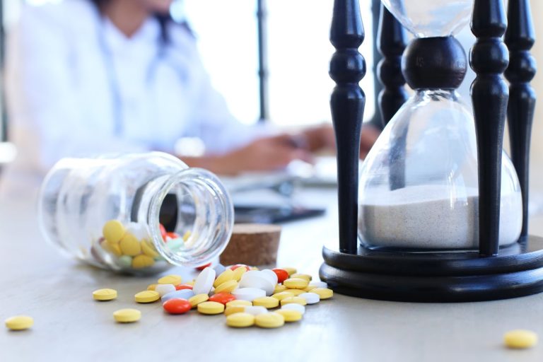doctor office with pills and hourglass