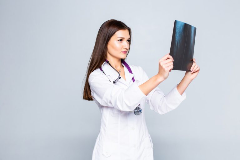 female doctor examining x-ray image isolated