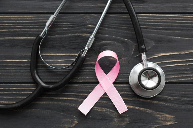 pink ribbon stethoscope dark background